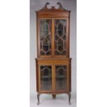 An Edwardian inlaid-mahogany tall standing corner cabinet fitted four shelves enclosed by two