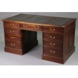 A reproduction mahogany pedestal desk inset black leatherette, fitted three frieze drawers, with two