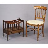 A mahogany two-division canterbury fitted with a long drawer, & on turned legs with steel castors,