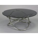 A contemporary coffee table with a circular tempered smoked-glass top, & on a silvered-metal base,
