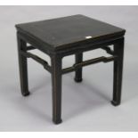 A Chinese black lacquered hardwood square occasional table on four square tapered legs with shaped
