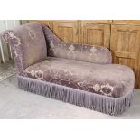 A Victorian-style chaise lounge with a scroll ends, shaped back & padded seat upholstered mauve &
