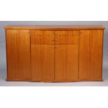 A Skovby (Danish) cherry wood serpentine-front sideboard fitted two long graduated drawers to centre