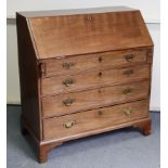 An 18th century mahogany bureau, the fitted interior enclosed by sloping fall-front, four long