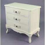 A continental-style white-finish small serpentine-front chest fitted three long drawers, & on