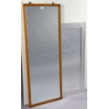 A 1950’s oak frame rectangular wall mirror stamped “AM” to back, 48” x 18”, together with two