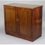 A mid-20th century record cabinet with a fitted interior enclosed by a pair of panel doors, & on a