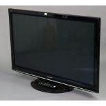 A Panasonic 52” television with a remote control.