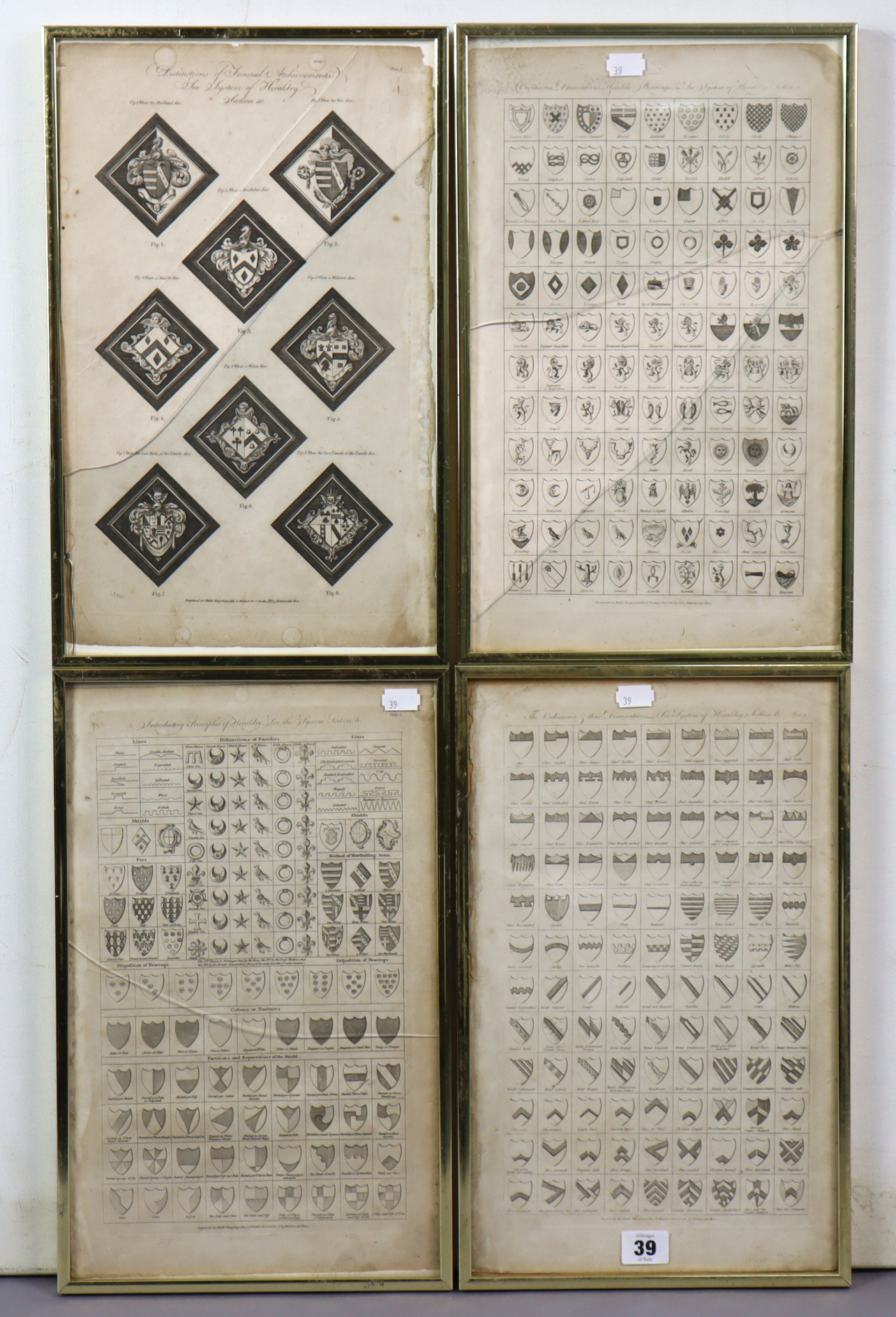 Four vintage engravings - all depicting family crests, 15½” x 9½”, in matching glazed frames.