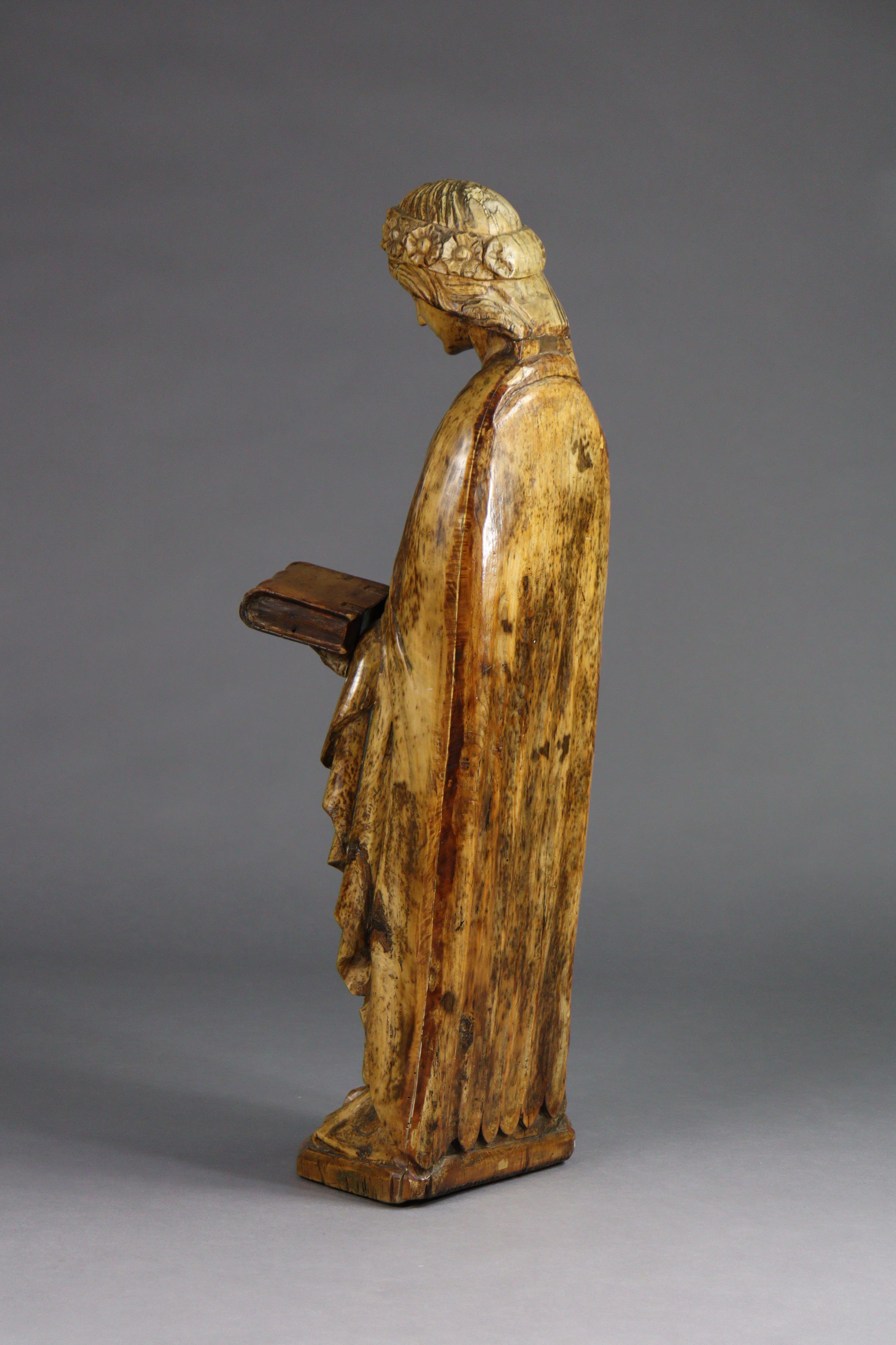 A carved limewood figure of St. Catherine, wearing floral crown, holding a book in her left hand ( - Image 3 of 7