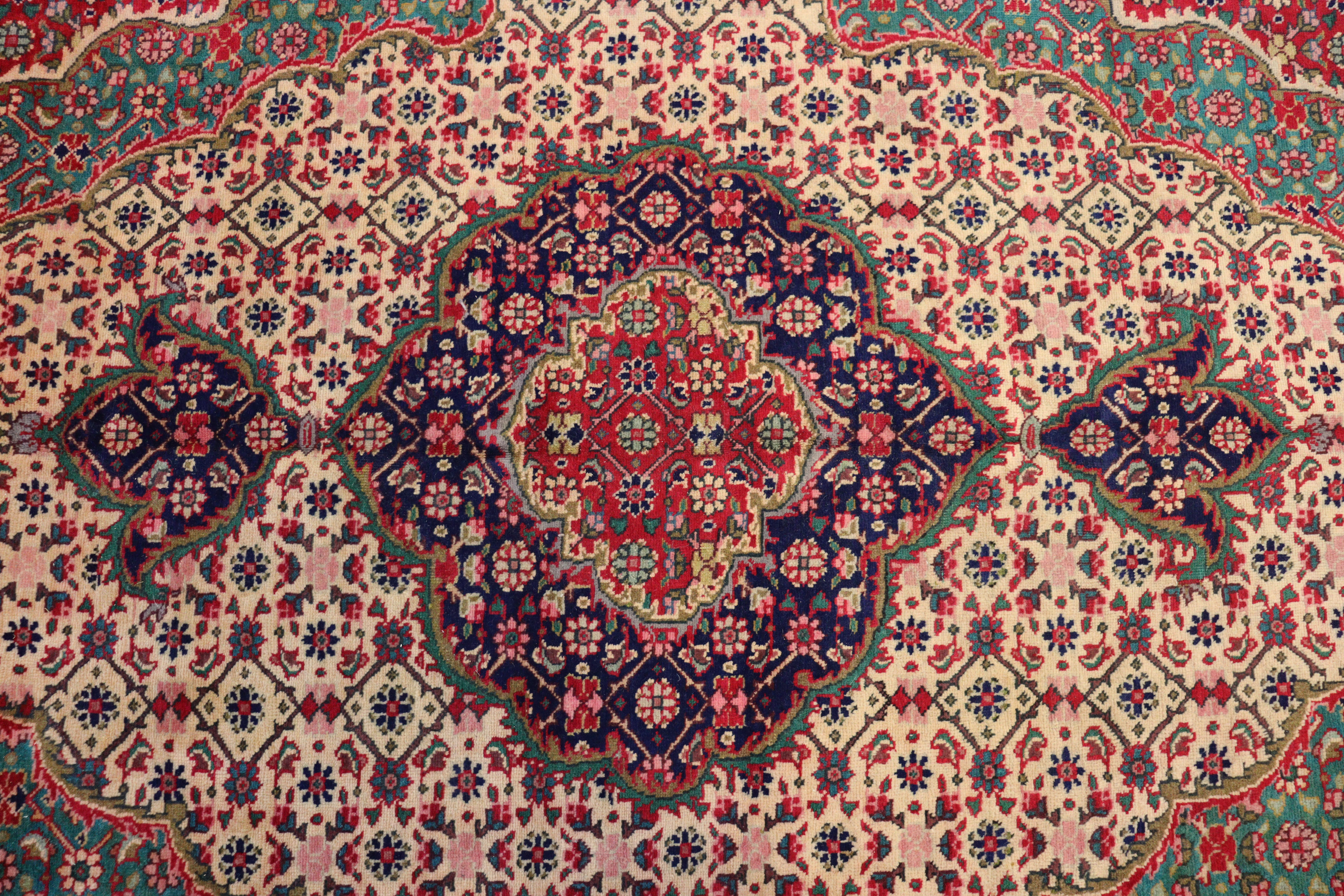 A NORTH WEST PERSIAN TABRIZ CARPET, with a central medallion surrounded by floral motifs, within wi - Image 2 of 4