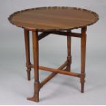 A mahogany folding coaching or occasional table by CHARLES BAKER of Bath, with pie-crust edge to the