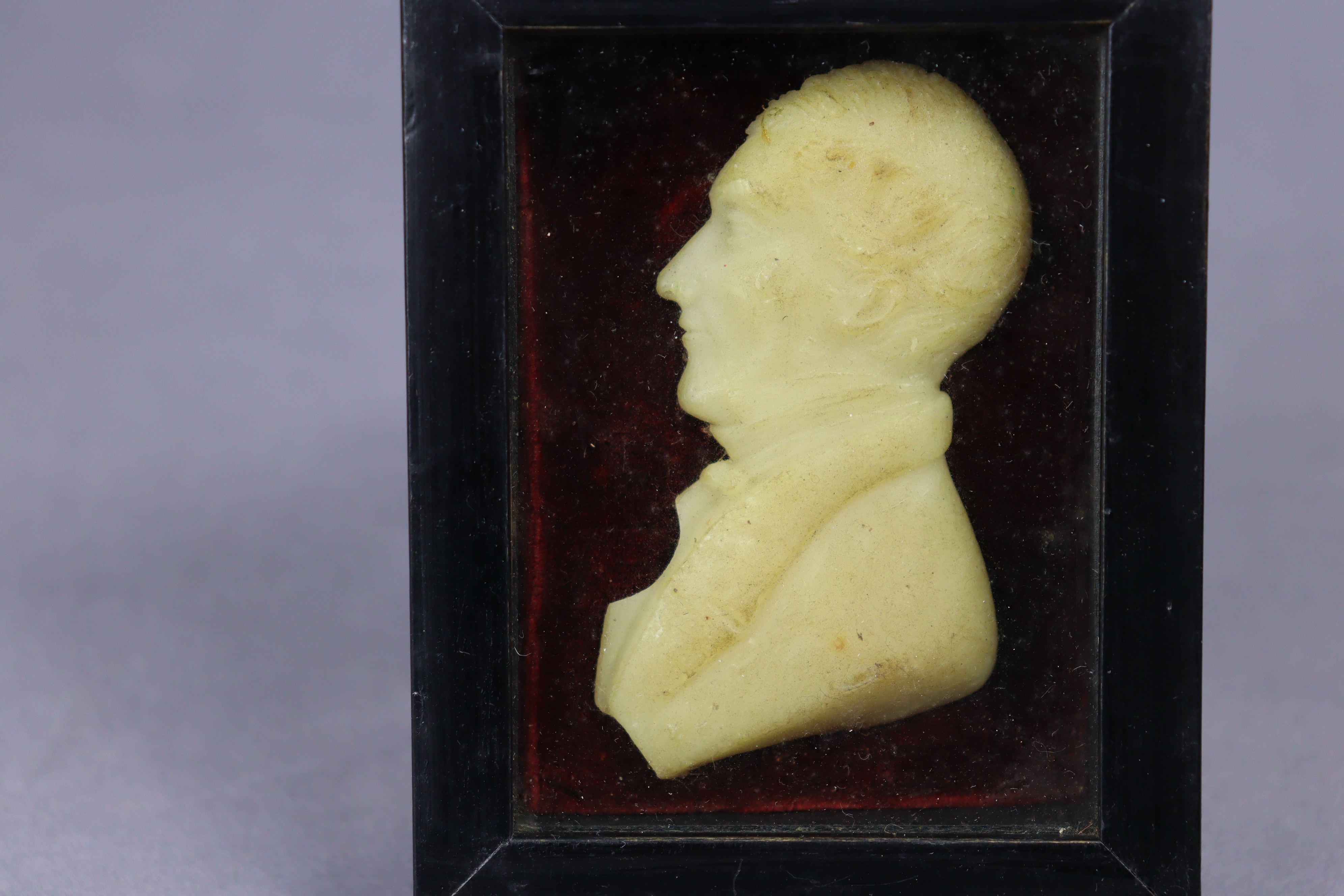 A 19th century wax relief portrait of Rev. John Huyshe, bust-length, in profile, mounted to velvet - Image 2 of 2