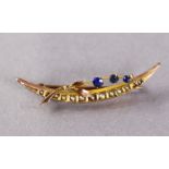 A 9ct. gold crescent & frond brooch set three small simulated sapphires & a row of seed pearls (1.