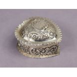 A Victorian silver heart-shaped trinket box with embossed floral decoration & hinged lid, 3¾” wide,