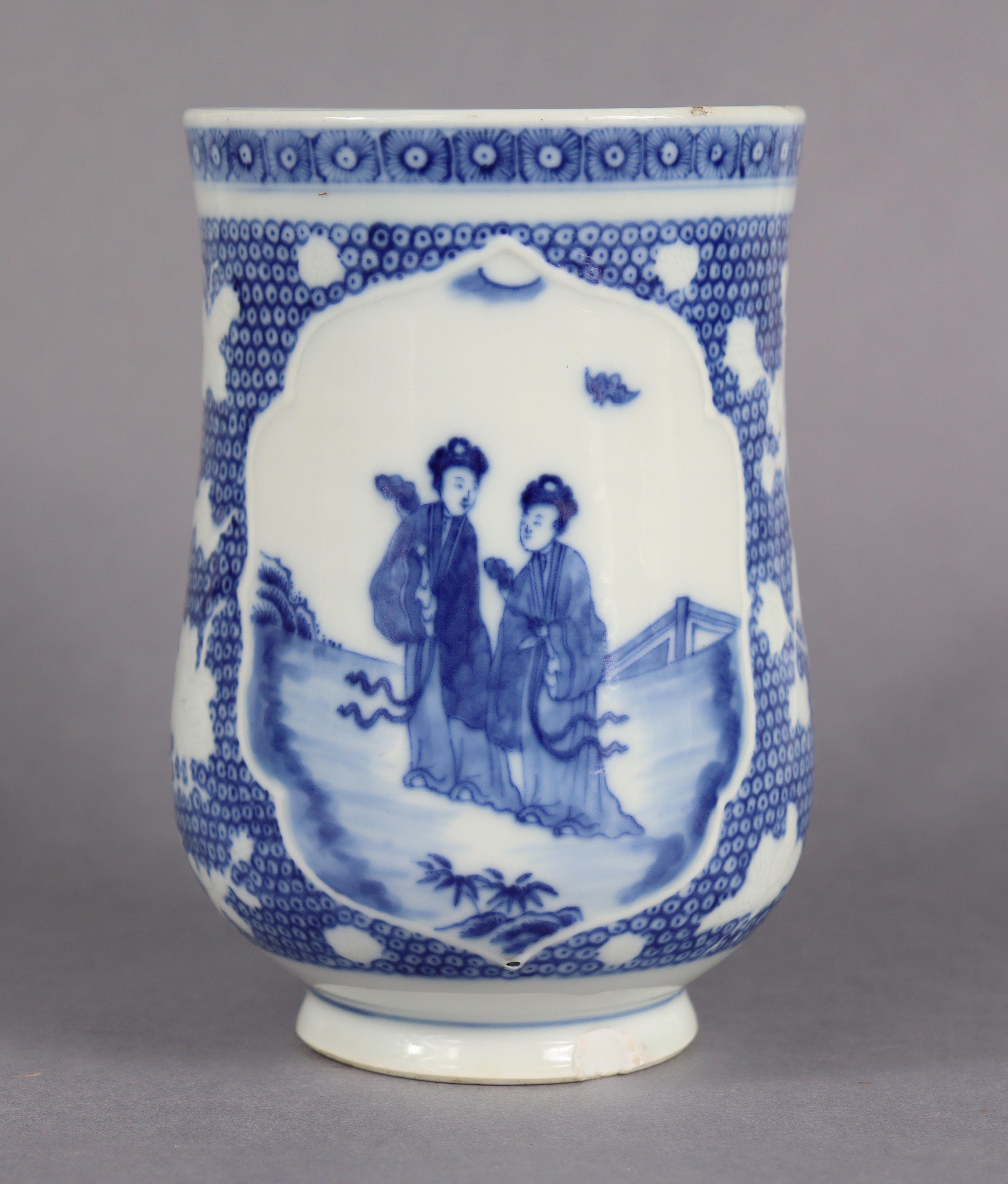 An 18th century Chinese blue & white porcelain tankard of baluster form. The central cartouche