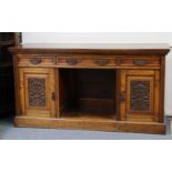 A late Victorian burr-oak sideboard, with carved floral decoration to the fielded panel doors