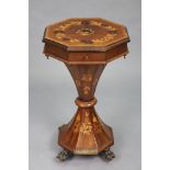 A Victorian inlaid mahogany needlework table of octagonal form with fitted interior, on tapered cent