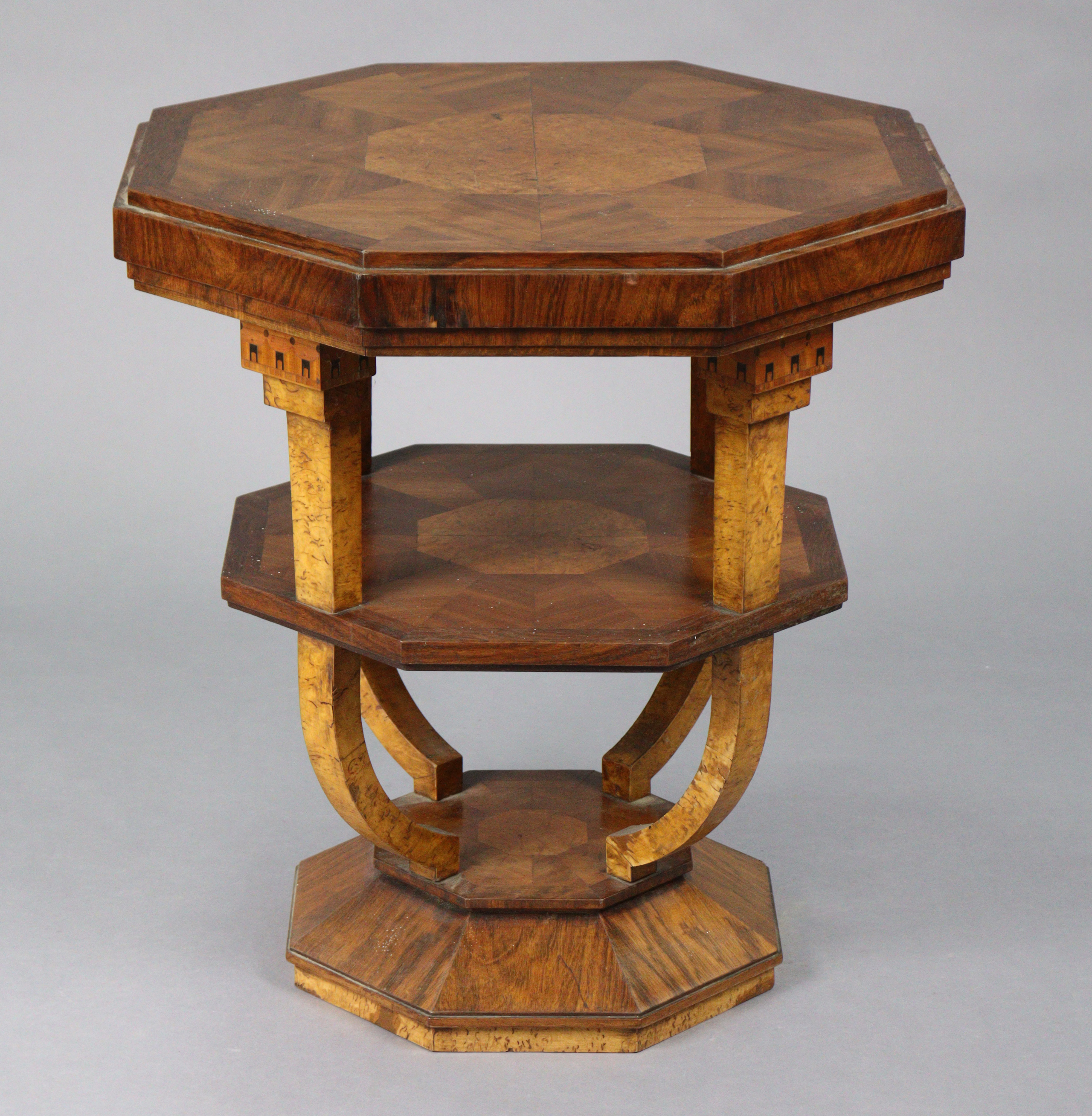 A mahogany Art Deco octagonal three-tier occasional table, each tier with amboyna-veneered centre