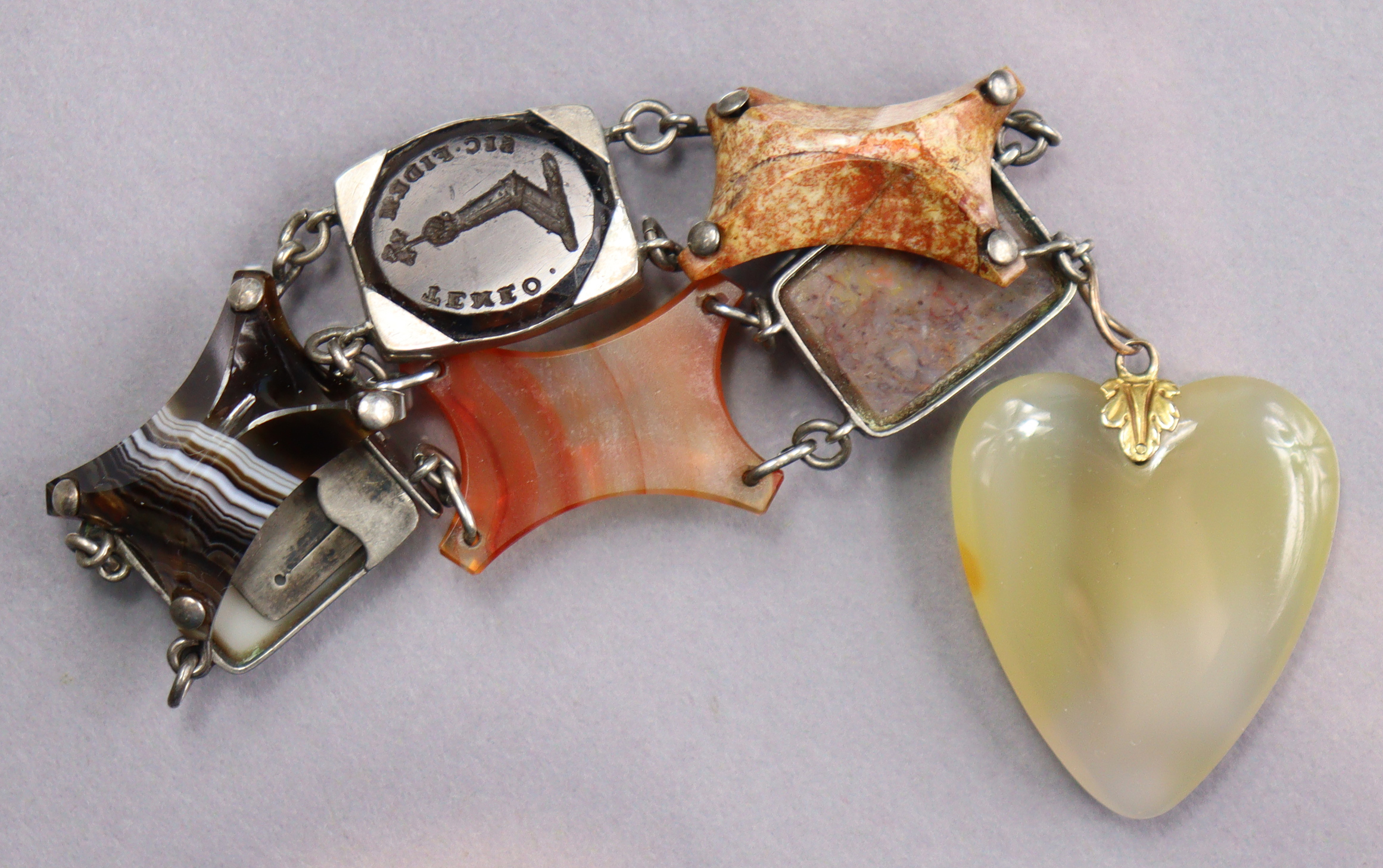 A Scottish flexible hardstone bracelet comprising various coloured stones, an intaglio seal, & with - Image 2 of 3