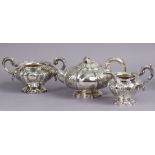 A GEORGE IV/EARLY VICTORIAN SILVER THREE-PIECE TEA SERVICE, of melon shape with embossed floral dec
