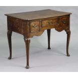 An 18th century oak lowboy, with re-entrant corners to the rectangular top, fitted three frieze