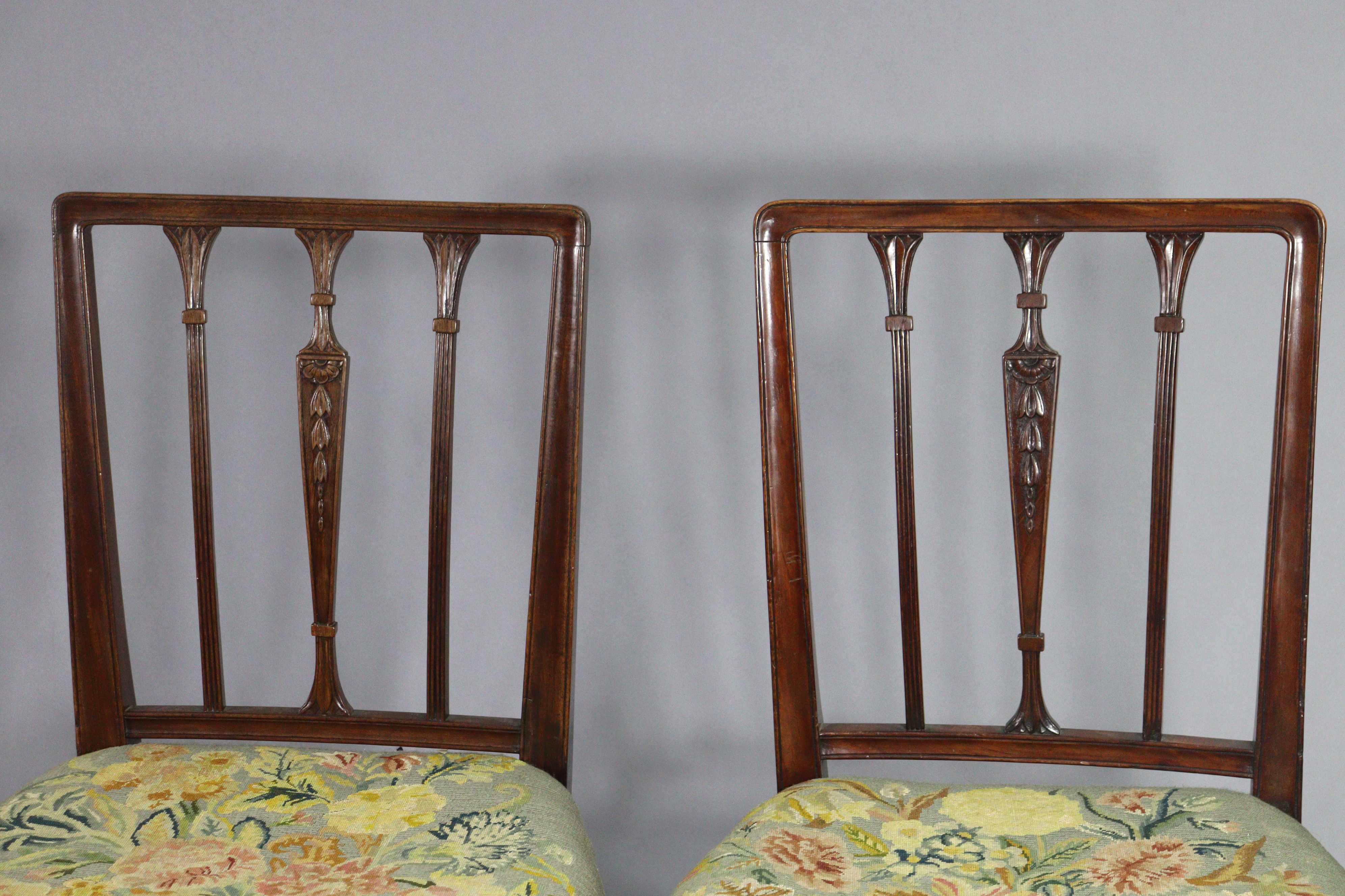 A set of four 19th century dining chairs with carved foliate decoration to the rail-backs, padded - Image 3 of 6