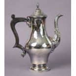 An Elizabeth II silver coffee pot of inverted pear shape in the early George III style, on round