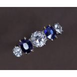 A DIAMOND & SAPPHIRE RING, the centre diamond approx. 0.5carat, flanked by a cushion-shaped sapphire