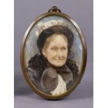A late Victorian portrait miniature of an elderly lady, dressed in black, 2¾” x 2” (oval), in