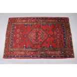 A north west Persian Zanjan rug of madder ground, the central medallion surrounded by floral &