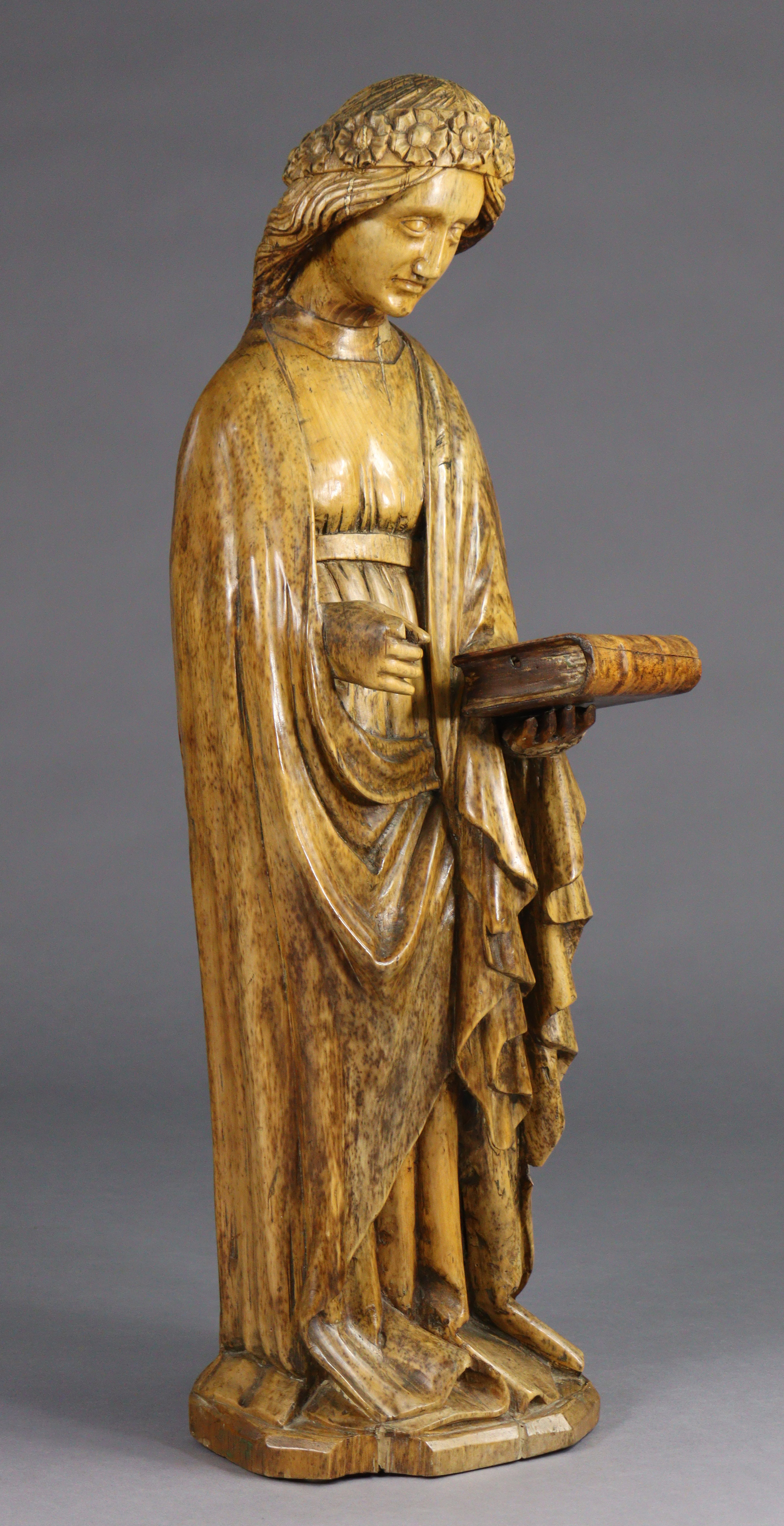 A carved limewood figure of St. Catherine, wearing floral crown, holding a book in her left hand ( - Image 2 of 7