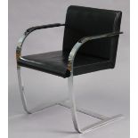 After Mies Van Der Rohe; a Brno flat-bar armchair with black leather padded arms & seat, 23” wide