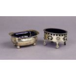 A George III silver oblong salt cellar with gadrooned rim, on four ball feet, & with blue glass line