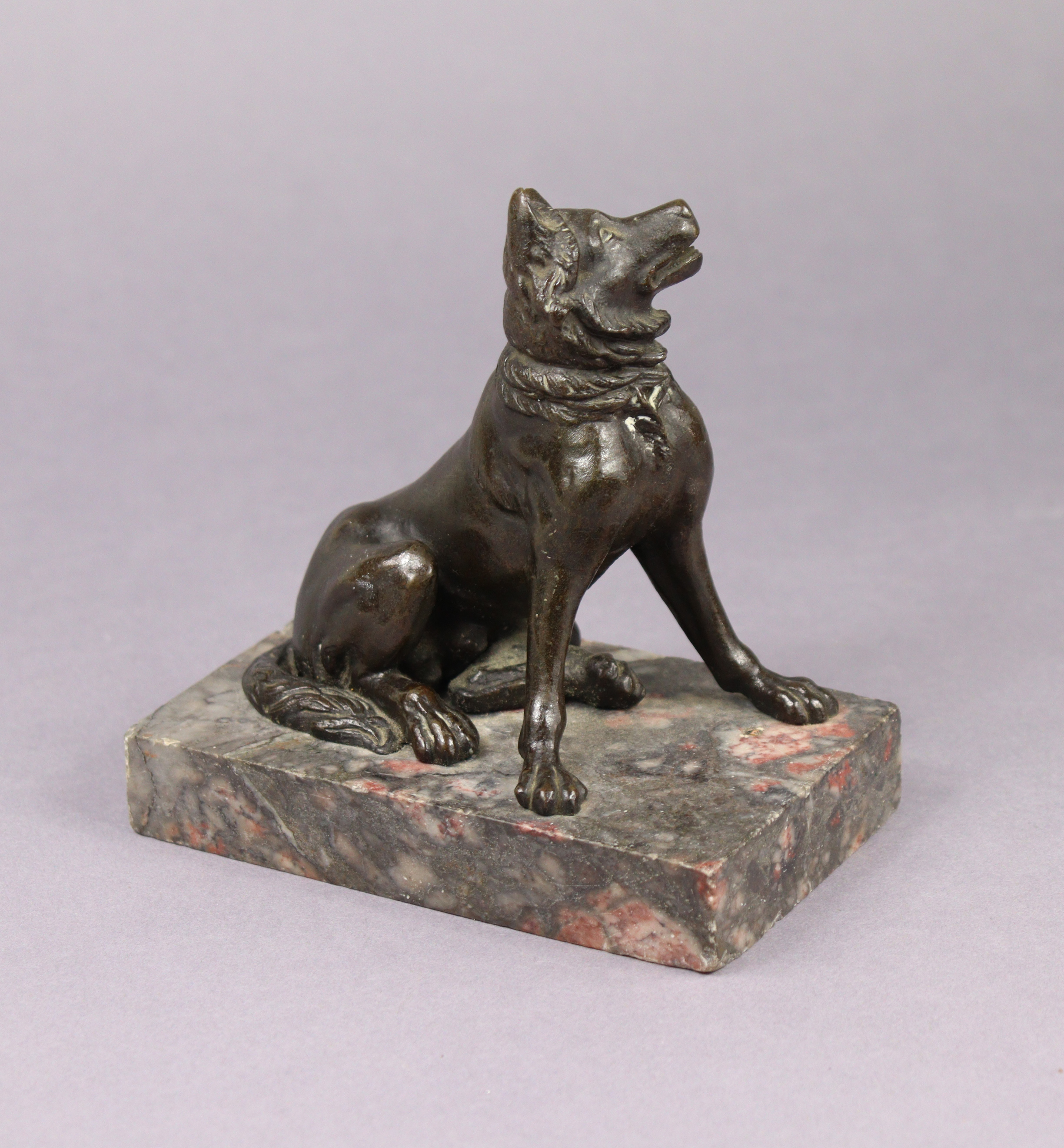 A Grand Tour bronze model of a seated dog, on marble rectangular base, 5¼” high x 5” wide.