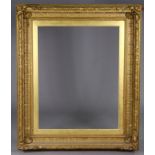 A large 19th century giltwood & gesso picture frame, with foliate decoration & scallop shell corners