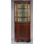 A 19th century inlaid mahogany standing corner display cabinet, with moulded cornice above three