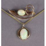 An opal pendant, the oval stone set in yellow metal mount, with “rolled-gold” fine-link chain