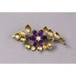 A 9ct gold leaf-spray & flower brooch set oval amethysts & a seed pearl, 5cm wide. (6g)