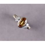 An 18ct white gold ring set oval citrine, pairs of small diamonds either side, size K. (5.4g)