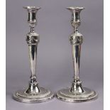 A pair of George III style plated candlesticks, the round tapered columns with key borders & embosse
