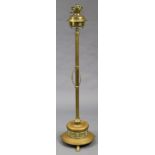 A late 19th/early 20th century adjustable floor-standing oil lamp with neoclassical decoration, on