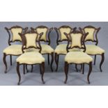 A set of six Victorian rosewood dining chairs with shaped & carved centre rails to the open backs,