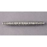 A palladium bar brooch set row of nineteen graduated diamonds, 2½” long. (5.3g)