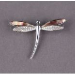 An 18ct white gold dragonfly brooch, the wings set small diamonds & mother-of-pearl, 4cm wide. (7g)