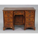 An early 18th century style mahogany & burr-walnut kneehole desk, the rectangular top with herringbo