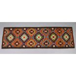 A Maimana kilim runner of ochre ground with repeating multicoloured geometric design within a single