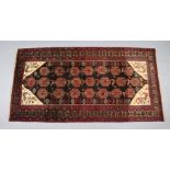 A north east Persian Meshed Belouch rug, the central field with repeating geometric design &