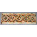 A Chobi kilim runner of ivory ground, multicoloured geometric designs surrounded by a single border,
