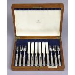 Six pairs of silver dessert knives & forks with narrow zig-zag borders to the tapering oval loaded